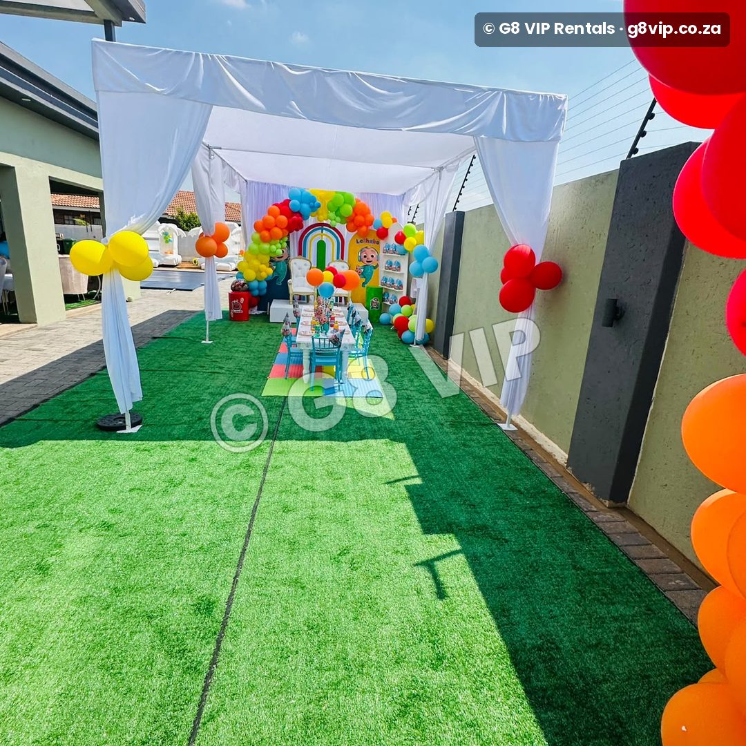 Platinum party by G8 VIP: draped tent with kids table and rainbow balloons
