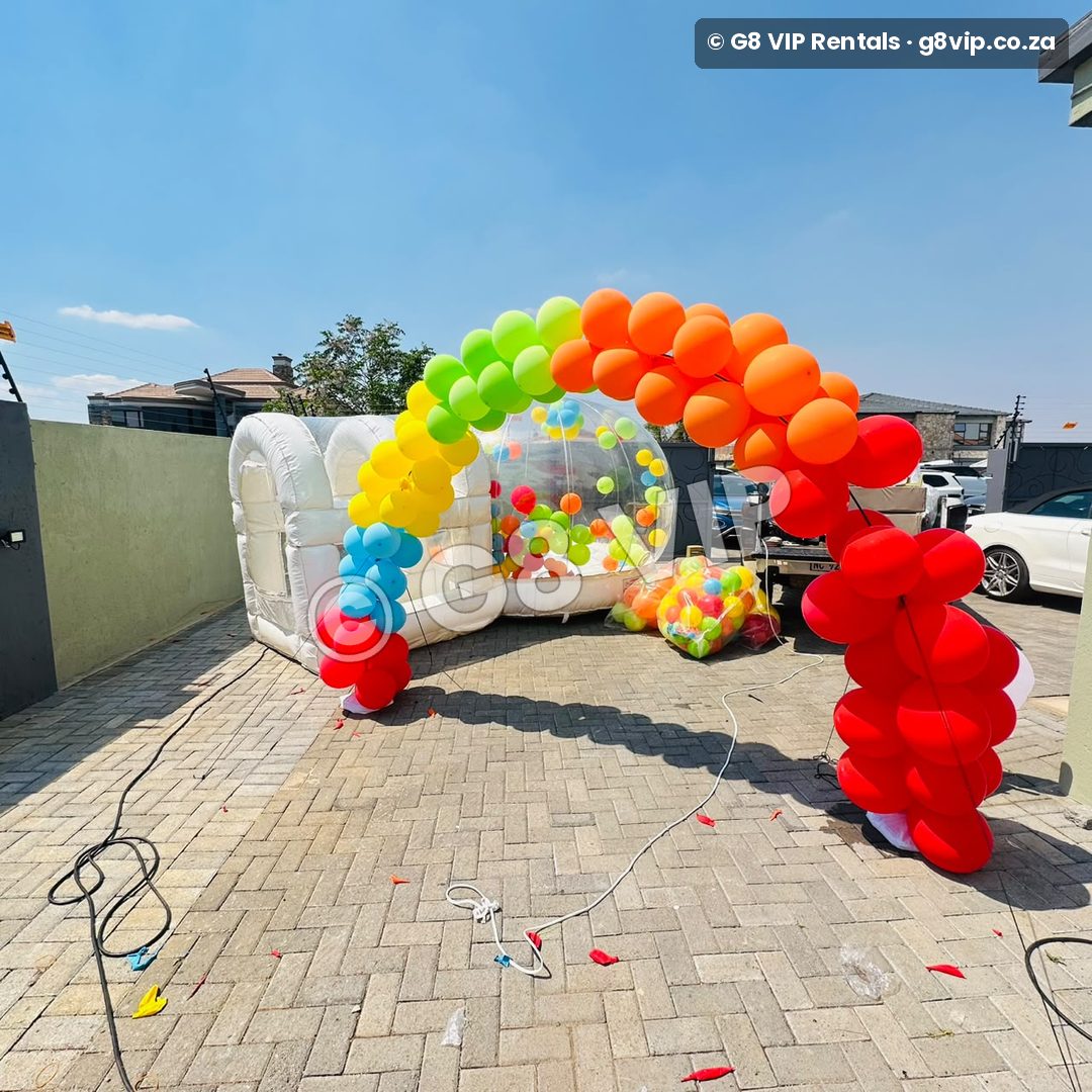 Platinum party by G8 VIP: rainbow balloon arch with Bubble House and white castle