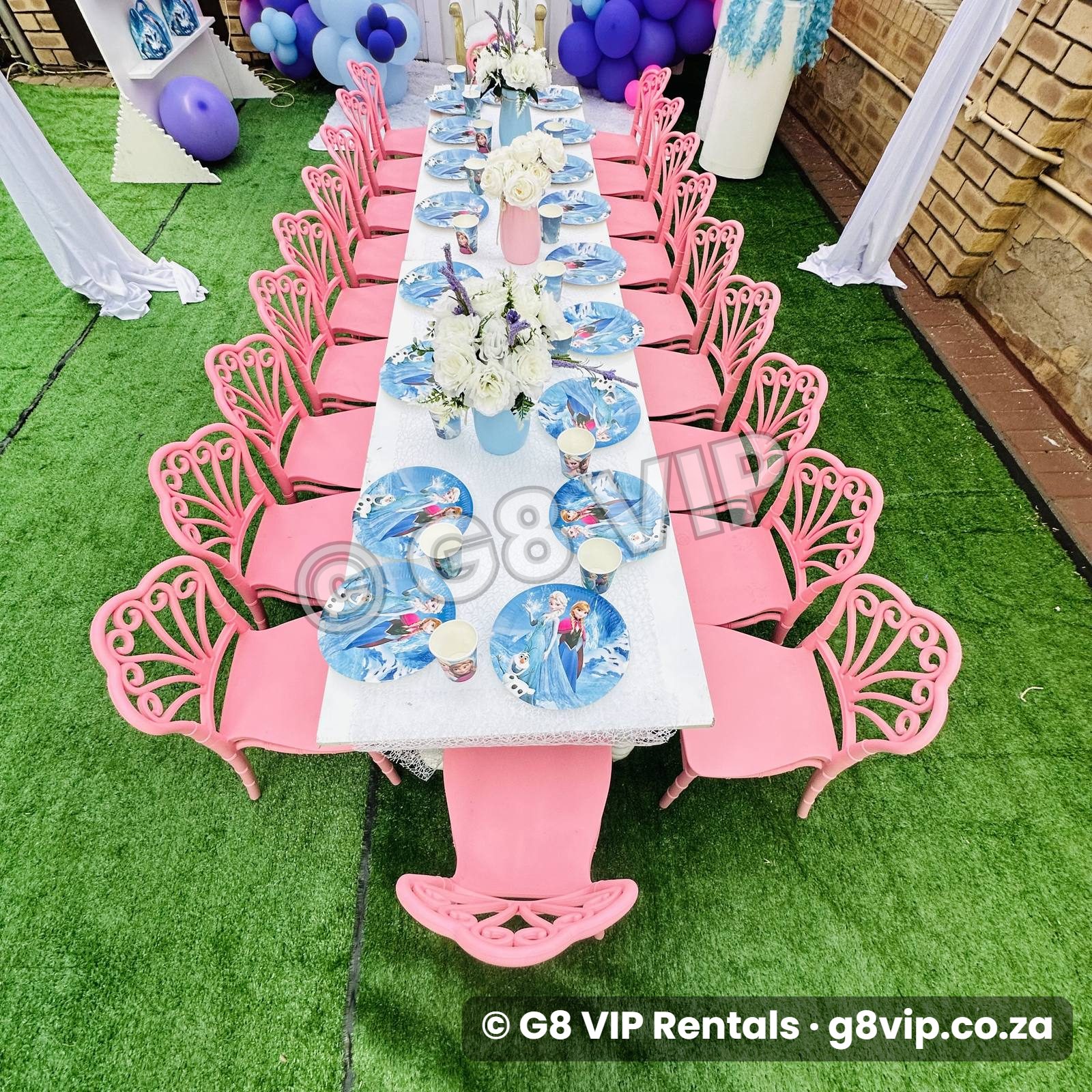 Pink decor range with balloon arch, pink chiavari chairs and styled Frozen theme table