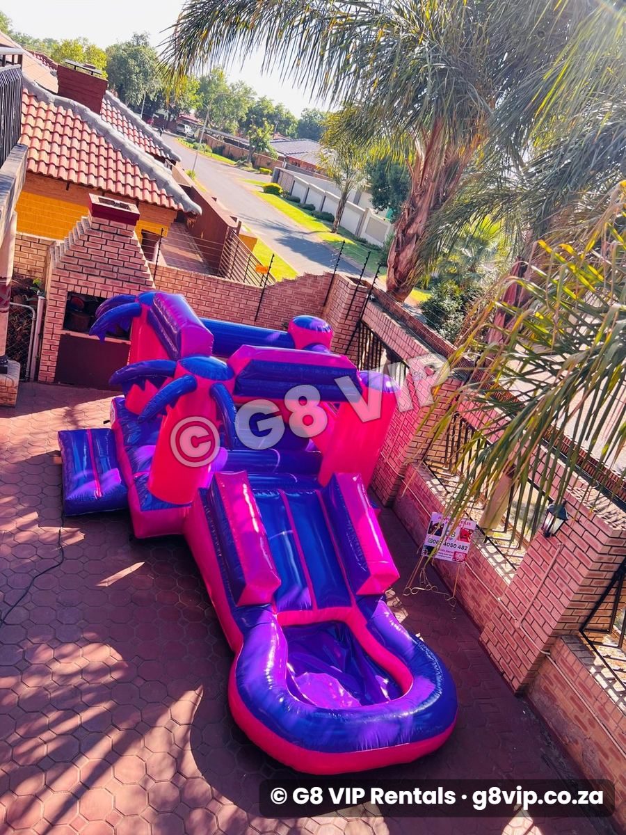 Purple Pink Castle jumping castle with slide and pool - from the front